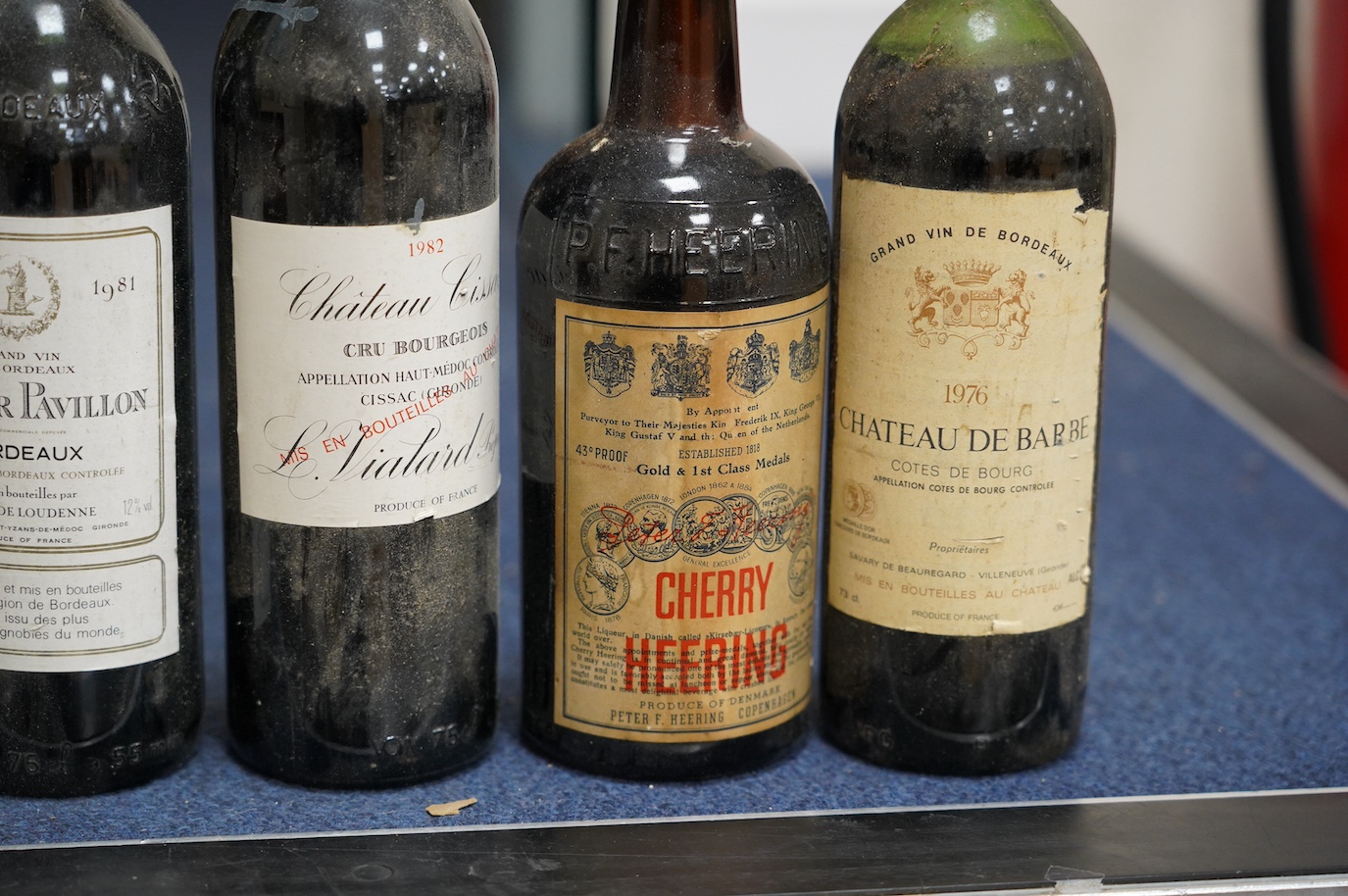 Eleven bottles of wine: Chateau Moulin Hargue 2003 x1, Chateaux Cissac 1982x2, Chateau la Coer Pavillion 1981 x2, Chateaux de barbe 1976 x1, Chateaux Haut Batailly 1998 x1, Premier Cotes de Bordeaux NV x1, Domain de Mart